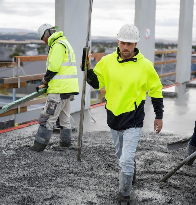 Rex Construct trades pouring and levelling a concrete slab on site